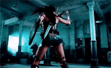 a woman in a superhero costume is holding a sword and shield in a dark room .