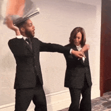 a man in a suit is throwing a newspaper at a woman in a suit