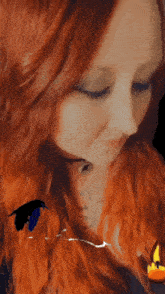 a woman with red hair has a tattoo on her chest that says ram
