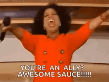 oprah winfrey is holding a microphone with her arms in the air .