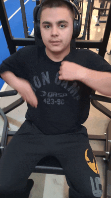 a young man wearing headphones and a shirt that says ' icon game ' on it