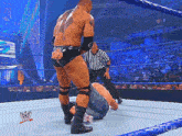 a man in a wrestling ring with a wwe logo on the ring ropes