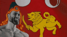 a man with a beard is smiling in front of a yellow lion