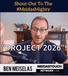 a man with glasses is talking into a microphone with the words " project 2026 " above him