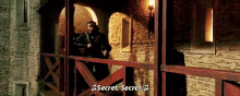 a man standing on a balcony with the words secret secret written on the bottom