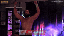 a wrestler named shane sabre is standing in front of a sign that says alpha 1 wrestling.com