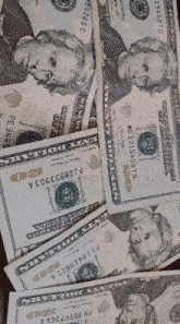 a pile of twenty dollar bills with a picture of a man on them