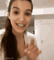 a woman is smiling and pointing at the camera with the hashtag murciano_21