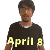 a man wearing glasses and a black shirt with the date april 8 on it