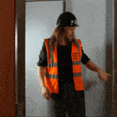 a man wearing an orange vest that says the old vic on it
