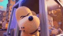 a stuffed animal with an angry face is looking out of a car window