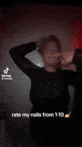 a woman is making a funny face with her mouth open while holding her hair in a tiktok video .