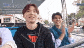 a group of young men are riding a boat with the word boy on the bottom