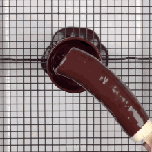 a piece of chocolate is being poured into a container