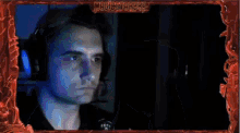 a man 's face is behind a frame that says magicstarkh on it