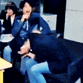 a group of people are laughing in a room with mint.delight written on the bottom right