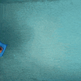 a man is floating in a swimming pool with a tray of food