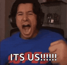 a man wearing headphones is shouting it 's us !!!