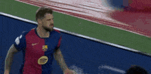 a man in a soccer jersey is running on a soccer field .