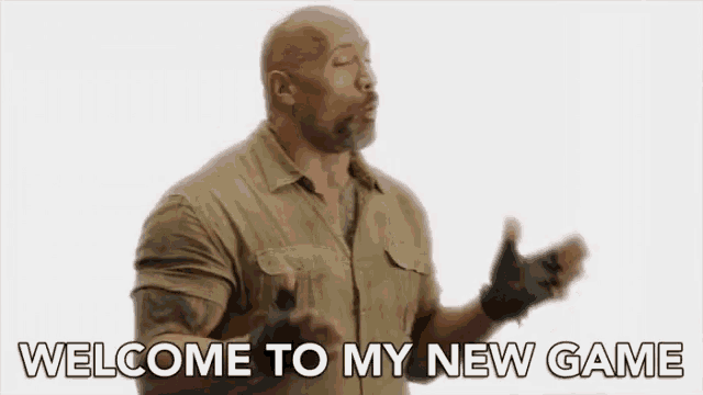 a man with a beard and gloves is standing in front of a white background and saying `` welcome to my new game '' .