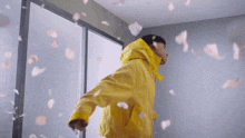 a person in a yellow coat is falling through the air