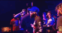 a group of people are dancing in front of a sign that says ' justice '