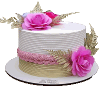 a white cake with pink flowers and gold leaves on top of it