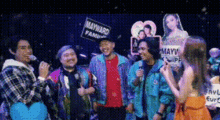 a group of people are standing in front of a sign that says mayward family