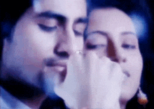 a close up of a man and woman holding hands .