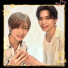 two young men are posing for a picture and one has a heart drawn on it