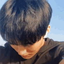 a close up of a man 's head with a blue sky in the background .