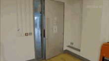 a man in a white tank top is walking through a door with rte one written on the bottom