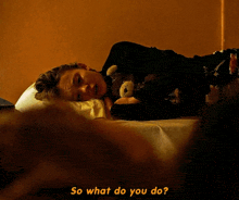 a person laying on a bed with a teddy bear and the words " so what do you do "