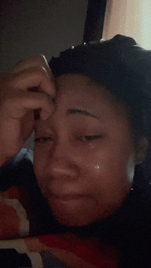 a close up of a woman 's face with tears running down her face