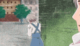 a man and a girl are standing next to a green brick wall