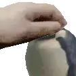 a pixelated image of a person 's hand touching a penguin 's nose .