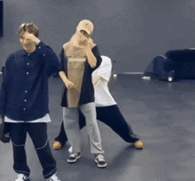a group of young men are dancing in a room and one of them is wearing a hat that says mlb on it