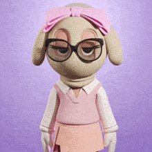 a stuffed animal with glasses and a pink headband