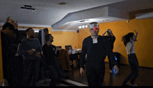 a man wearing a card that says ' i love you ' on it walks in a dark room
