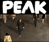 a group of people are walking in front of a black background that says peak