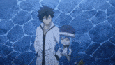 a man and a woman are standing next to each other in front of a blue wall