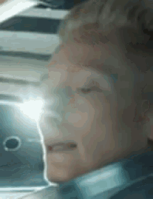a close up of a person 's face with a light shining through it