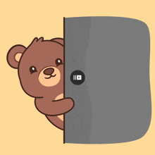 a brown teddy bear is peeking out from behind a door