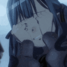 a close up of a girl covering her eyes with her hands