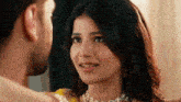 a man and a woman are looking at each other .