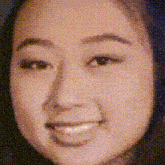 a close up of a woman 's face with a smile .