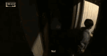a person laying on a bed in a dark room with the word no on the bottom right