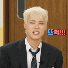 a man in a suit and tie is making a face