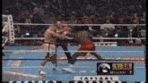 two boxers in a ring with a sign that says caesars round 1 on it