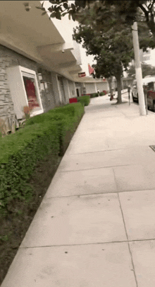 a sidewalk in front of a building with a sign that says ' a ' on it